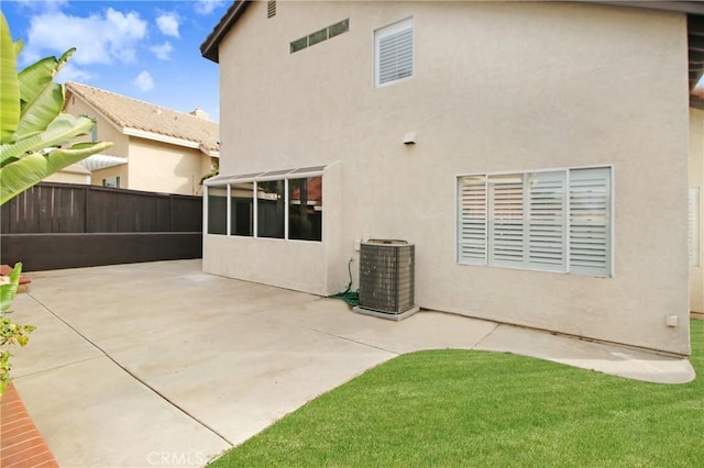 rear view of property with a patio area and central air condition unit