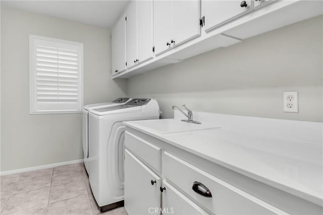 laundry room featuring sink, light tile patterned flooring, cabinets, and independent washer and dryer