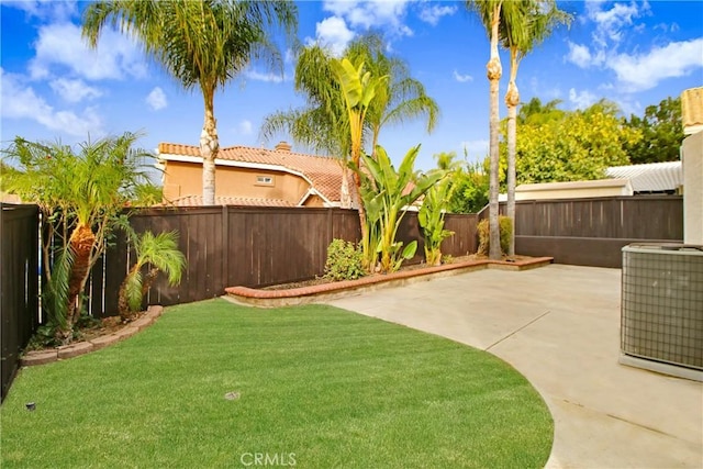 view of yard featuring central air condition unit and a patio