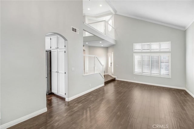 unfurnished living room featuring ornamental molding, dark wood-type flooring, and high vaulted ceiling