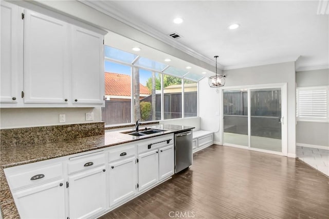 kitchen with dishwasher, sink, dark hardwood / wood-style flooring, dark stone countertops, and white cabinets