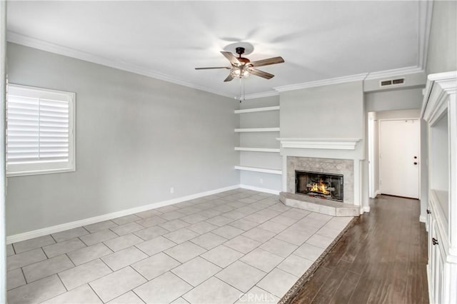 unfurnished living room with built in shelves, light hardwood / wood-style floors, ornamental molding, and ceiling fan