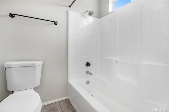 bathroom with tile patterned floors, toilet, and washtub / shower combination