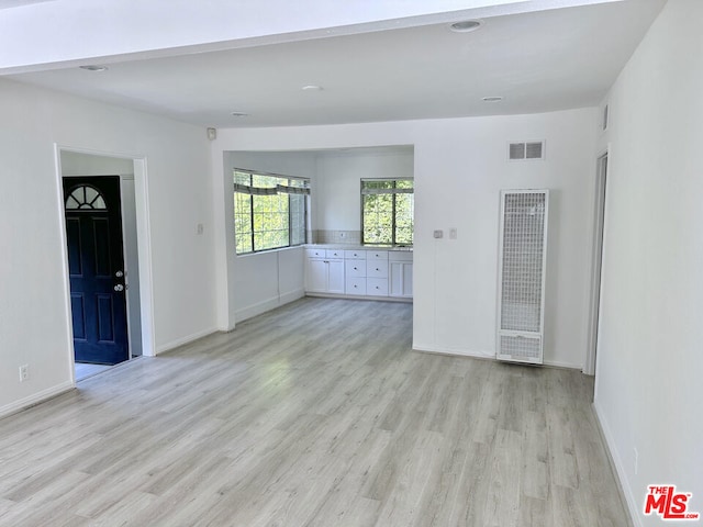 unfurnished living room featuring light wood-type flooring