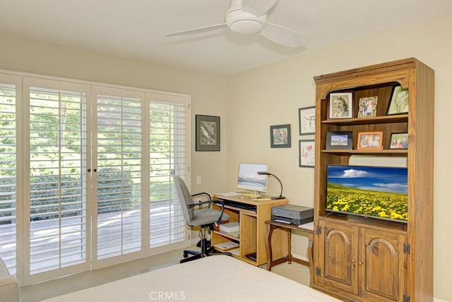 home office featuring light carpet and ceiling fan