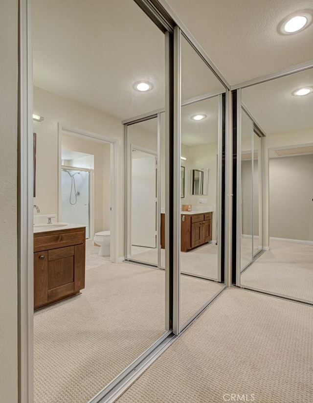 bathroom featuring vanity, toilet, and walk in shower