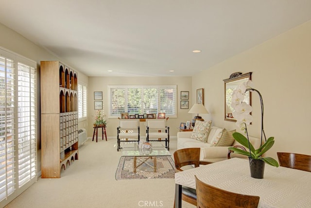 living room featuring plenty of natural light and light carpet