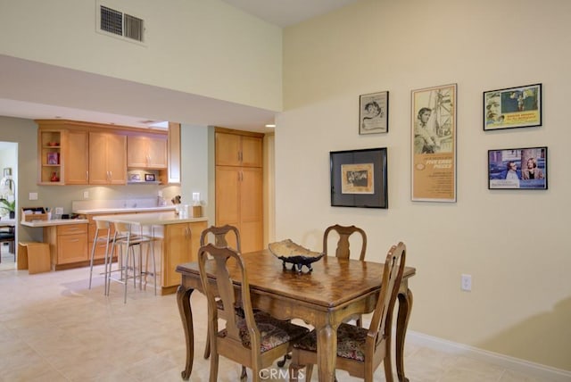 dining area featuring a high ceiling