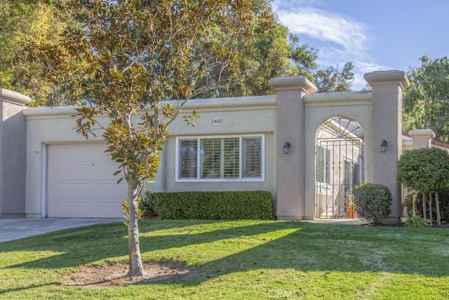 view of front of property featuring a garage and a front lawn