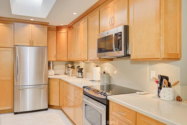 kitchen with light brown cabinets, light tile patterned floors, and appliances with stainless steel finishes