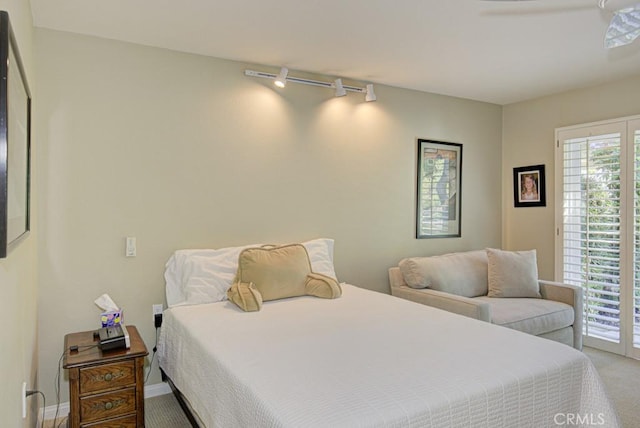 bedroom featuring ceiling fan, access to exterior, carpet floors, and rail lighting