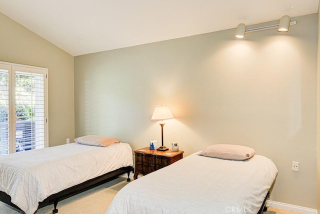 bedroom featuring carpet flooring and lofted ceiling