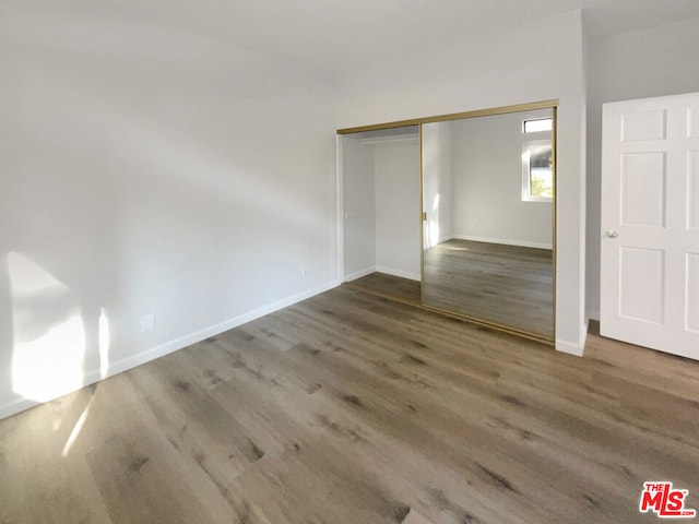 interior space featuring dark hardwood / wood-style floors and a closet