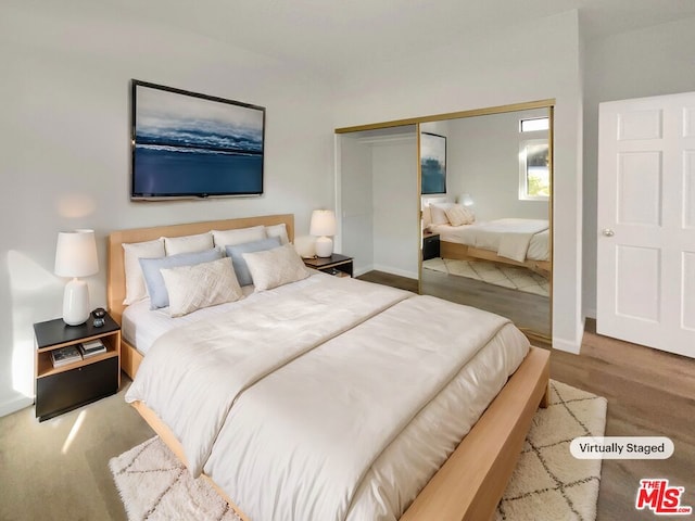 bedroom with hardwood / wood-style flooring and a closet