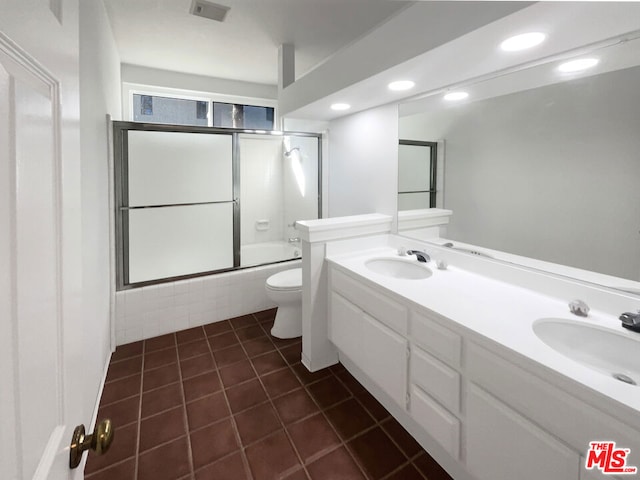 full bathroom with tile patterned flooring, vanity, toilet, and shower / bath combination with glass door