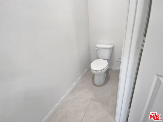 bathroom with tile patterned floors and toilet