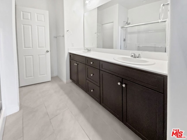 bathroom with tile patterned flooring, vanity, and an enclosed shower