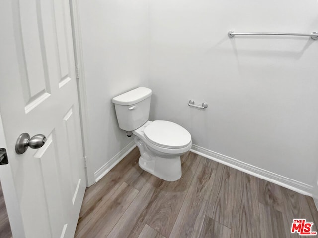 bathroom featuring hardwood / wood-style floors and toilet