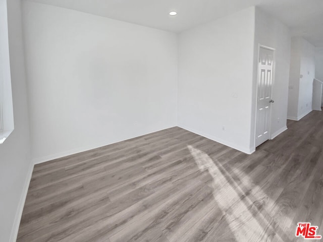 spare room with dark hardwood / wood-style flooring