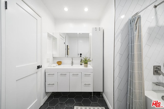 bathroom featuring tile patterned floors, vanity, and shower / tub combo