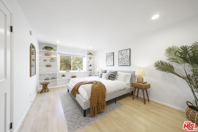 bedroom with light wood-type flooring