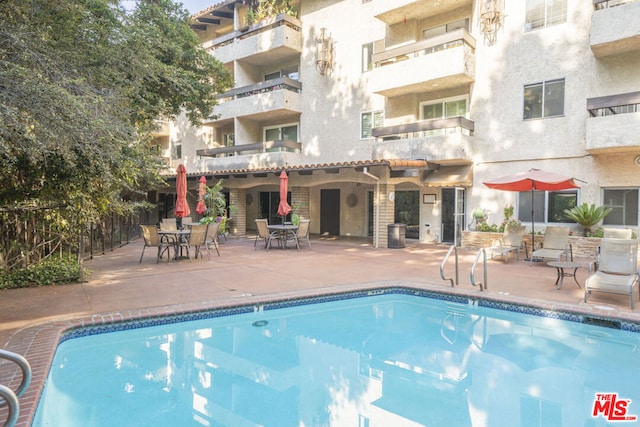 view of swimming pool with a patio