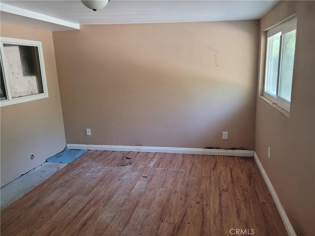 unfurnished room with hardwood / wood-style flooring