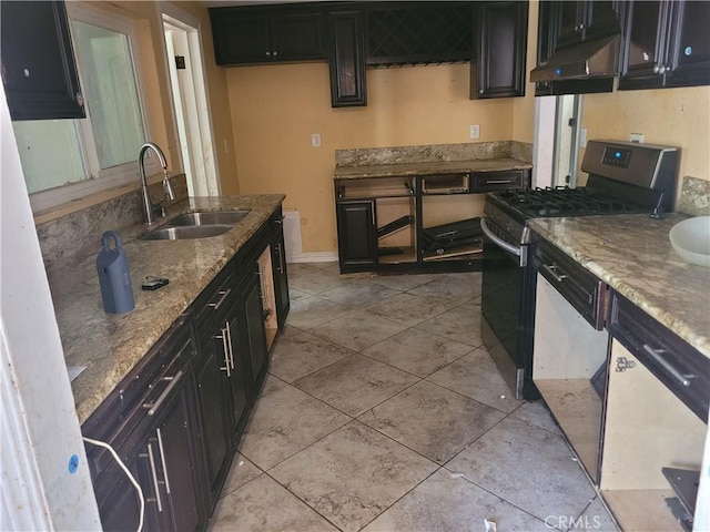 kitchen with black gas stove, sink, light stone countertops, light tile patterned floors, and dishwashing machine