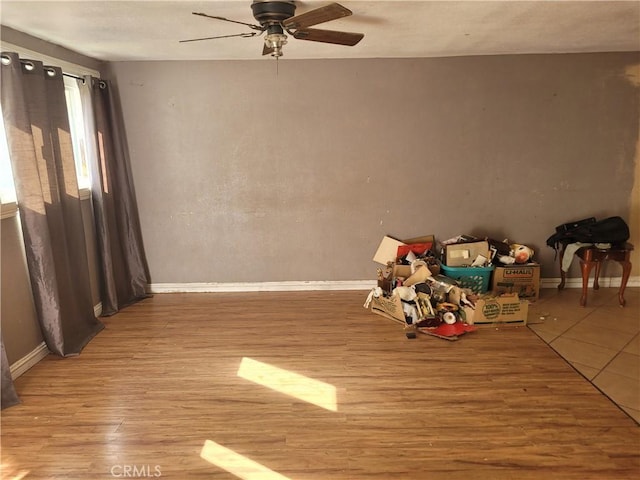 interior space with wood-type flooring and ceiling fan