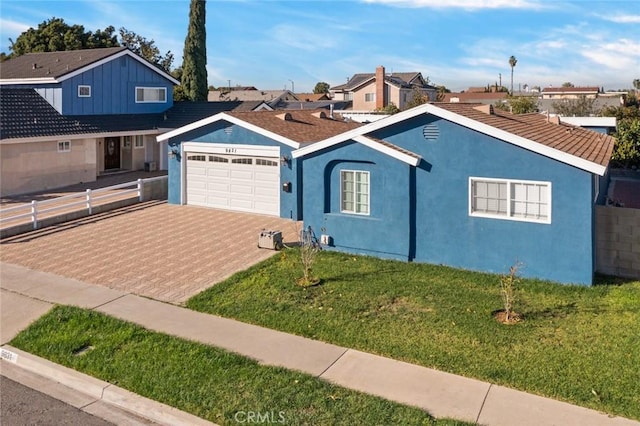 view of front of home with a garage and a front yard