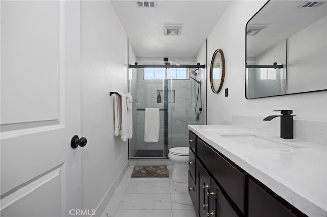 bathroom featuring vanity, toilet, and a shower with shower door