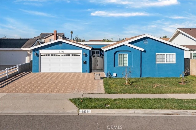 ranch-style house with a garage and a front yard