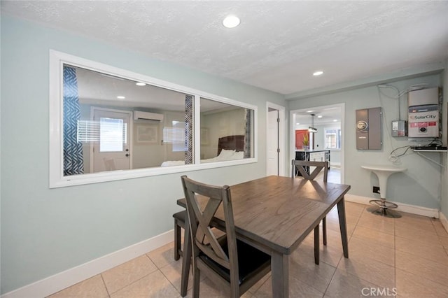 dining area featuring light tile patterned floors, a textured ceiling, an AC wall unit, and sink