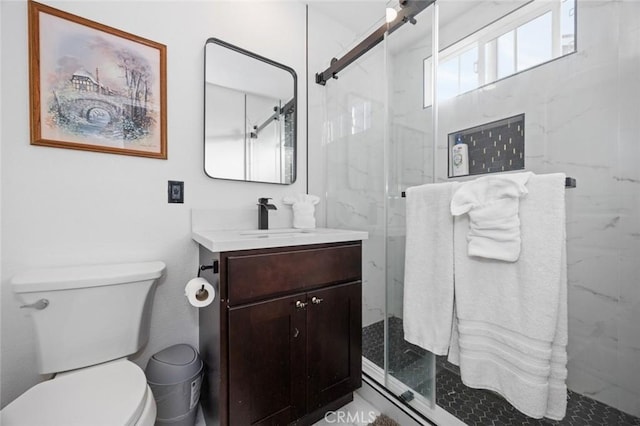 bathroom with vanity, toilet, and walk in shower