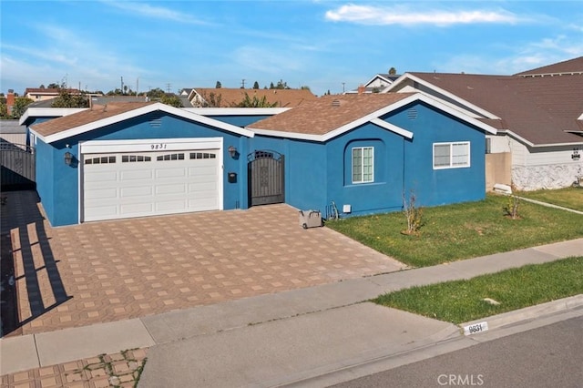 ranch-style house with a garage and a front yard