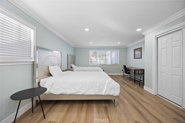 bedroom with light hardwood / wood-style floors and crown molding