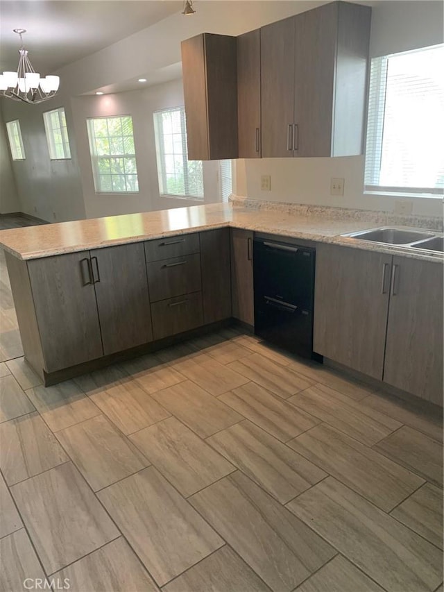 kitchen with dishwasher, sink, hanging light fixtures, kitchen peninsula, and a chandelier