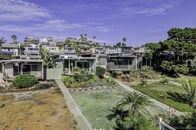 rear view of house featuring a yard