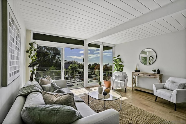 sunroom featuring beamed ceiling