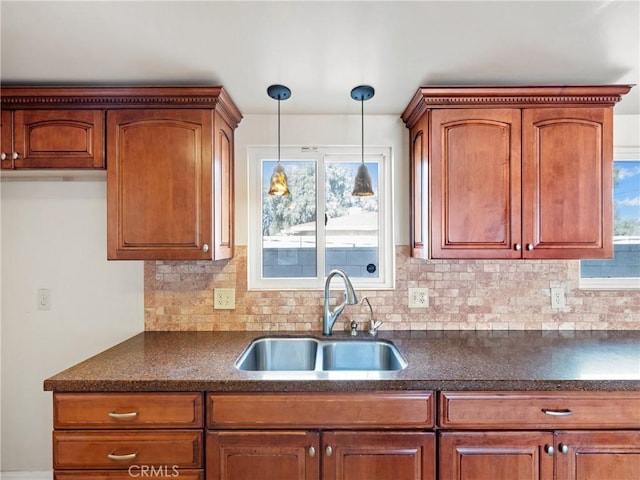 kitchen featuring decorative backsplash, sink, and decorative light fixtures