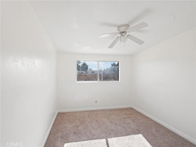 empty room with ceiling fan and light carpet