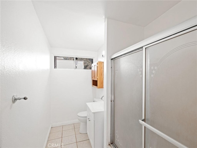 bathroom featuring toilet, vanity, tile patterned floors, and an enclosed shower