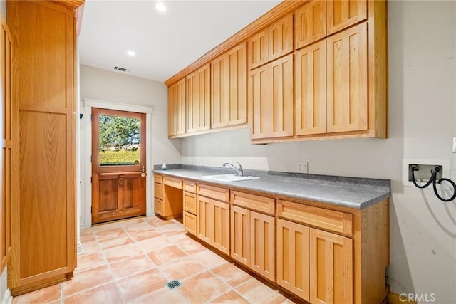 kitchen featuring light brown cabinets, light tile patterned floors, and sink