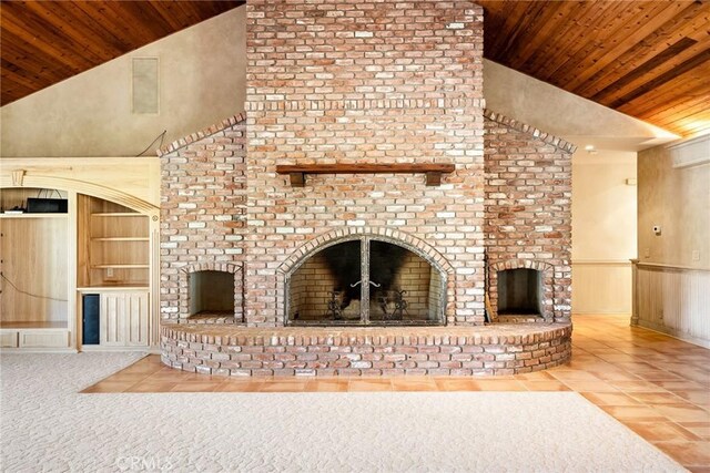 unfurnished living room with built in shelves, a brick fireplace, tile patterned floors, wooden walls, and wood ceiling