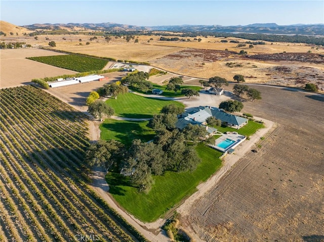 drone / aerial view featuring a mountain view and a rural view