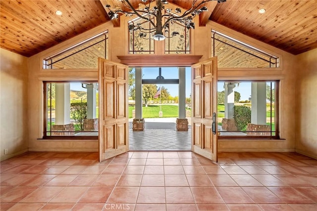 doorway to outside featuring beam ceiling, wooden ceiling, high vaulted ceiling, and a chandelier