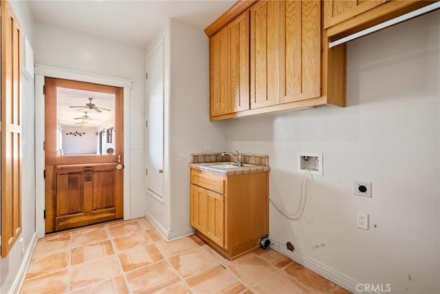 clothes washing area featuring ceiling fan, sink, cabinets, hookup for an electric dryer, and hookup for a washing machine