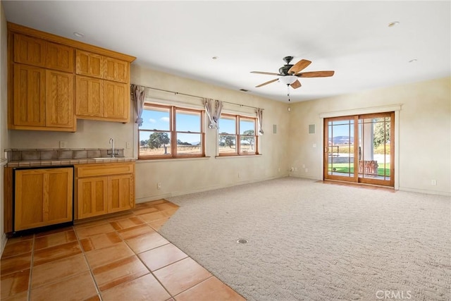 kitchen with plenty of natural light, ceiling fan, sink, and light carpet