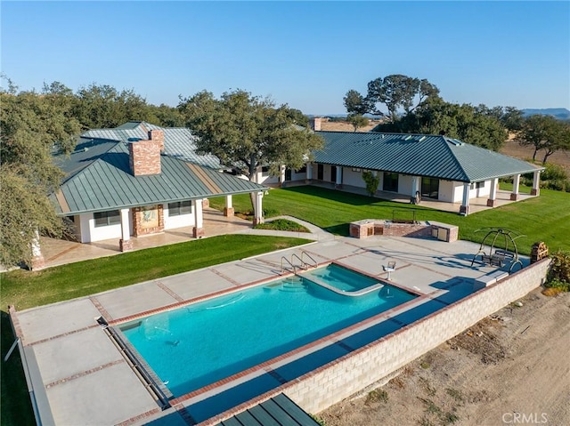 view of swimming pool featuring a lawn and a patio