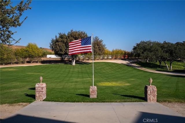 view of property's community with a yard